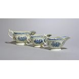 Three Worcester blue and white sauceboats, c.1765-75, in two sizes, moulded and painted with the