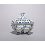 A Derby blue and white chestnut basket and cover, c.1765, of circular form, painted to the
