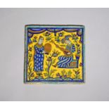 A late Safavid (Iran) cuerda seca tile, 17th century, decorated with two figures, one seated and