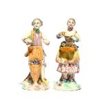 A near pair of miniature Mennecy figures of market traders, c.1760, one standing behind a tall