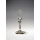 A wine glass, c.1750, the bell bowl with a solid teared base raised on an airtwist stem with swollen