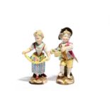 A pair of Meissen figures of children, 19th century, the boy carrying a basket of flowers, his