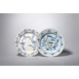 Two delftware chargers, c.1740-60, one painted in blue with polychrome highlights, with a large