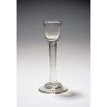 An Irish cordial glass, c.1740, the small rounded funnel bowl raised on a thick plain stem above a