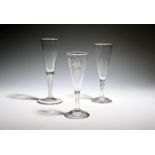 Three ale glasses or flutes, c.1760-70, one with a drawn trumpet bowl engraved with hops and