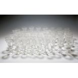 A suite of glass, early 19th century, the bowls variously drawn trumpet or round funnel, all