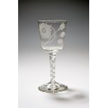 A large Jacobite glass goblet, c.1760, the generous bucket bowl engraved with a six petal rose and
