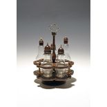 A treen and glass cruet, 2nd half 18th century, the wooden stand fitted with five glass bottles with