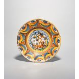 A North Italian maiolica charger, c.1720, boldly enamelled with a putto carrying fruit and