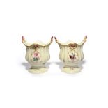 A pair of Meissen vases or urns, mid 18th century, the fluted sides moulded with flowers, painted