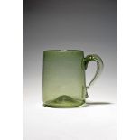 A large Spanish glass mug or tankard, mid 18th century, of a pale green tone, slightly tapering to