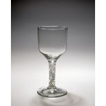 A large glass goblet, c.1760, the generous ogee bowl raised on a multi series opaque twist stem