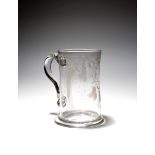 A large engraved glass ale mug or tankard, c.1760, engraved with the initials 'B / IM' within sprays