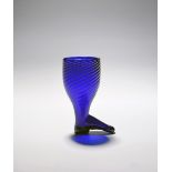 A large and rare blue glass stirrup cup, c.1790-1800, the wrythen moulded body tapering to a small