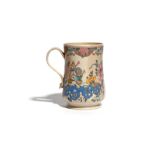 A Staffordshire salt-glazed mug, c.1760-70, the slightly waisted form enamelled with flowering peony