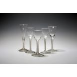 Five various wine glasses, c.1760, a pair with a band of spiral moulding, one with a bell bowl,