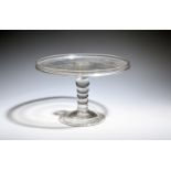 A glass tazza, c.1730, the flat circular top with galleried rim, raised on a five knopped bobbin