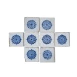 Eight Lambeth delftware tiles, c.1725-60, each painted in blue with a large rosette or stylized rose