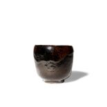 A JAPANESE BLACK RAKU WARE CHAWAN (TEA BOWL) MEIJI PERIOD OR LATER, 19TH OR 20TH CENTURY The tall