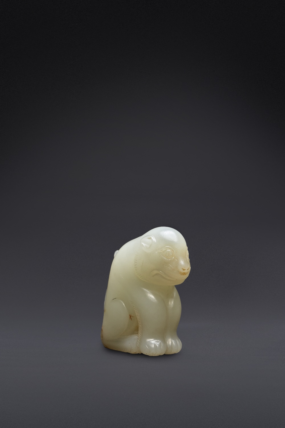 A RARE CHINESE PALE CELADON JADE FELINE PROBABLY SONG DYNASTY The feline seated on its haunches,