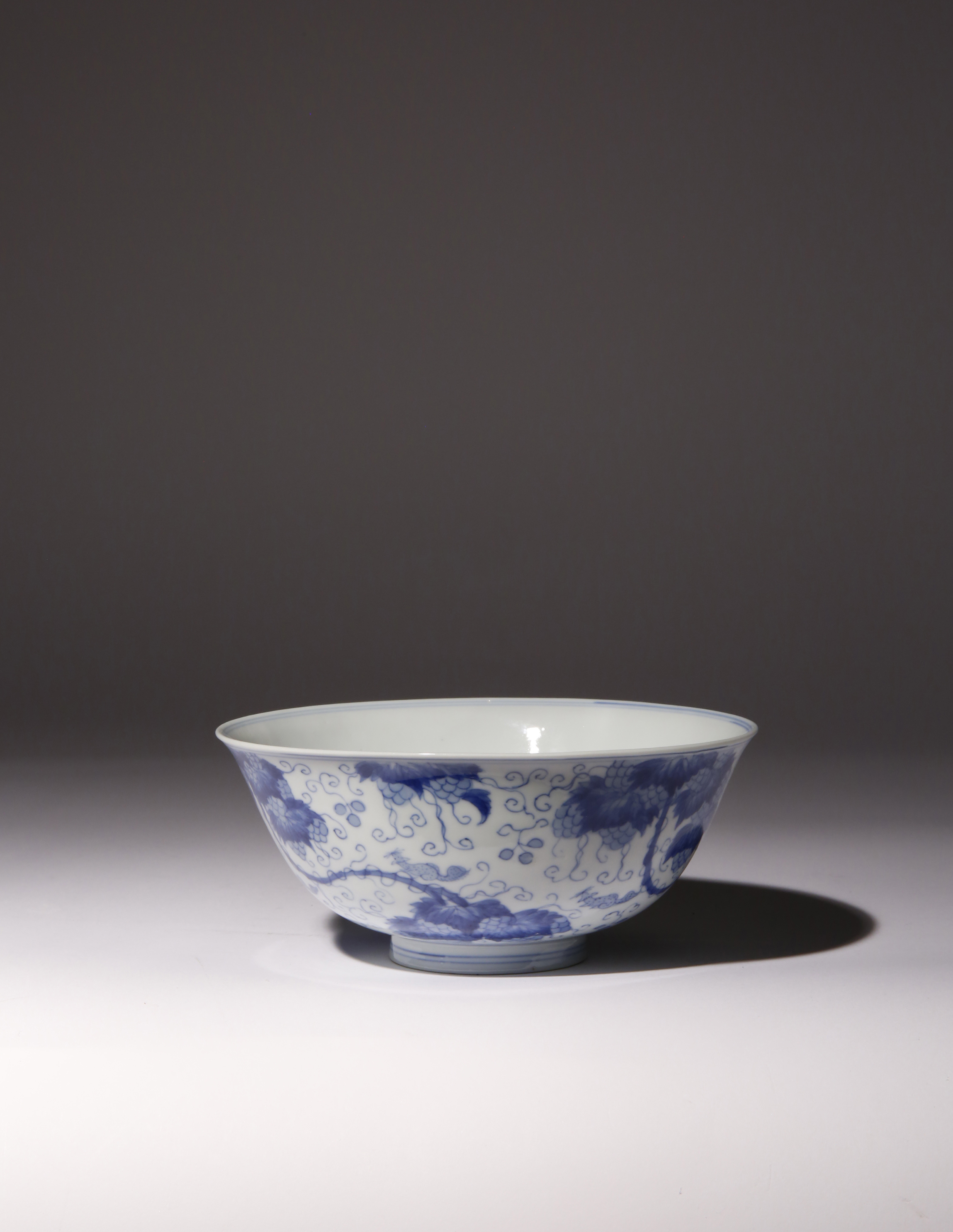 A CHINESE BLUE AND WHITE 'SQUIRRELS AND GRAPE VINE' BOWL KANGXI 1662-1722 The deep rounded sides