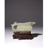 A CHINESE CELADON JADE ARCHAISTIC POURING VESSEL, YI 17TH CENTURY The rectangular body supported