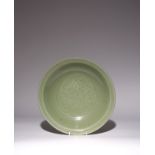 A CHINESE LONGQUAN CELADON 'LOTUS' DISH EARLY MING DYNASTY The heavily potted rounded sides rising