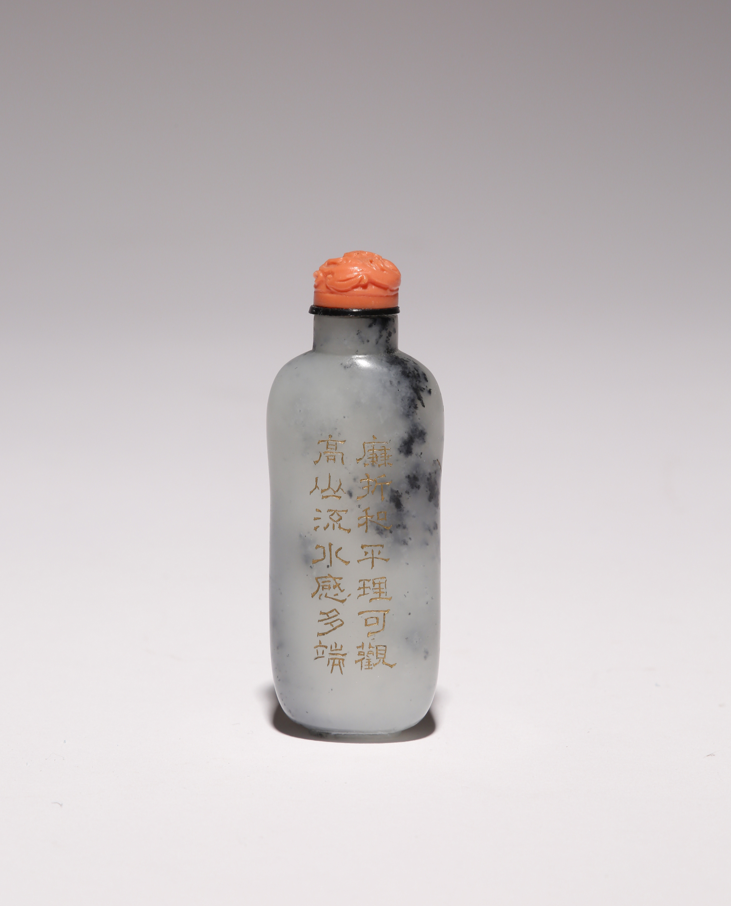 A CHINESE MOTTLED PALE GREY JADE CALLIGRAPHIC SNUFF BOTTLE 19TH CENTURY With an elongated body,