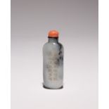 A CHINESE MOTTLED PALE GREY JADE CALLIGRAPHIC SNUFF BOTTLE 19TH CENTURY With an elongated body,