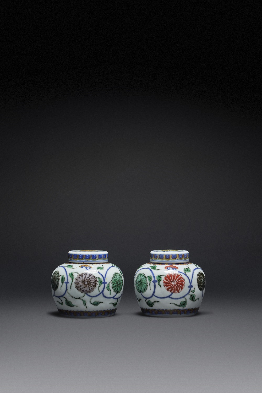 A RARE PAIR OF CHINESE WUCAI 'TIAN' JARS AND COVERS YONGZHENG 1723-35 The compressed circular bodies