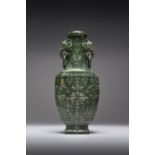 A LARGE CHINESE SPINACH-GREEN JADE VASE QIANLONG 1736-95 The flattened baluster body carved in