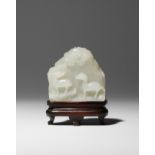 A SMALL CHINESE WHITE JADE 'MOUNTAIN' CARVING QIANLONG 1736-95 Formed as a rocky cliff face,