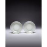 A RARE PAIR OF LARGE CHINESE WHITE JADE DISHES QIANLONG/JIAQING PERIOD Each raised on a straight