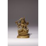 A TIBETAN GILT-BRONZE FIGURE OF MANJUSRI 15TH/16TH CENTURY Seated in dhyanasana upon a double