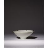 A CHINESE CARVED QINGBAI FOLIATE BOWL SONG DYNASTY The rounded sides rising to a lobed rim, the