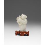 A CHINESE PALE CELADON JADE CARVING OF A BOY 18TH/19TH CENTURY The boy riding a hobby horse, with