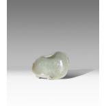A CHINESE PALE CELADON JADE 'LOTUS LEAF' WASHER QING DYNASTY OR LATER Naturalistically carved as a