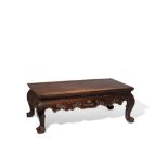 A CHINESE HARDWOOD KANG TABLE LATE QING DYNASTY The rectangular top above a shaped frieze carved