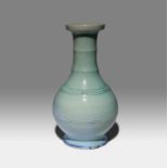 A CHINESE FLAMBE GLAZED VASE 18TH CENTURY The bulbous body surmounted by a tall ribbed neck and