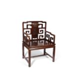 A CHINESE HARDWOOD OPEN ARMCHAIR LATE QING DYNASTY The central splat carved in relief with geometric
