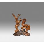 A CHINESE BURRWOOD CARVING OF A DEER QING DYNASTY Naturallistically carved as a deer standing by a