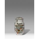 A CHINESE FAMILLE ROSE CYLINDRICAL JAR AND COVER 20TH CENTURY Decorated with vases fruits and