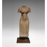 A KHMER BAPHUON STYLE SANDSTONE CARVING OF A FEMALE TORSO 11TH CENTURY OR LATER Standing in