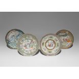 FOUR CHINESE CANTON FAMILLE ROSE PLATES LATE QING DYNASTY Vividly painted with figures in interiors,