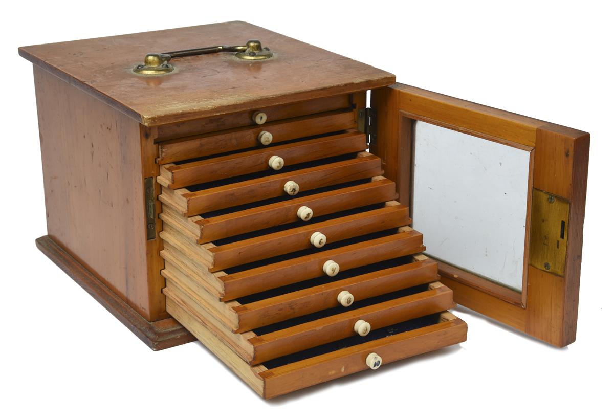 A small coin collectors cabinet, ten shallow drawers with bone handles, all enclosed by a glazed