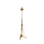 A copper and brass extending floor lamp probably WAS Benson, tripod foot with scrolling supports,