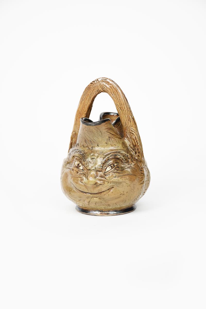 An unusual Martin Brothers stoneware grotesque face jug, dated 1890, modelled in low relief with a - Image 2 of 3