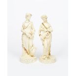A pair of tall W H Goss pottery Classical female figures, one modelled holding a lamb, the other