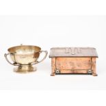 An A E Jones copper casket with hinged cover, rectangular form, cast strapwork decoration with