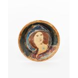 A Fulham Pottery plate by Quentin Bell, incised and painted to the well with a portrait of a